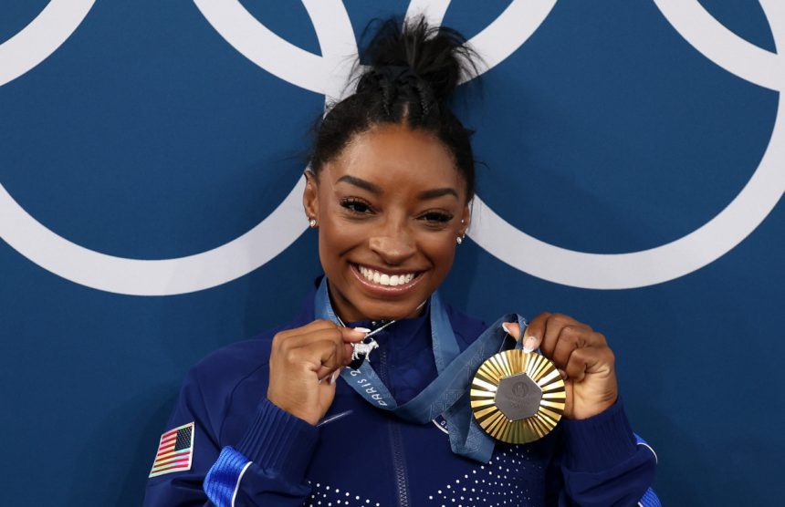 Unveiling the Inspiration: The Meaning Behind Simone Biles’s Iconic Goat Necklace & Ferragamo’s Dramatic Profit Decline